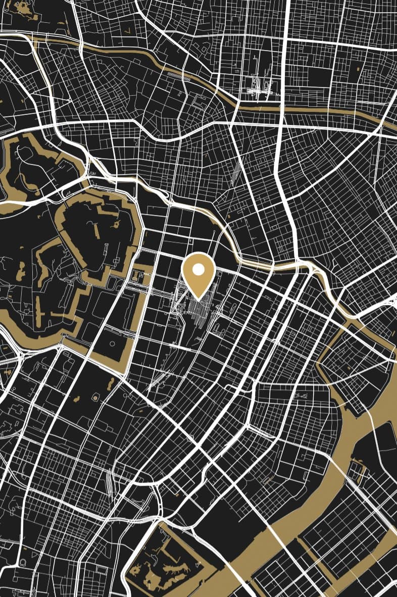 Central Tokyo's streets drawn in white on black, with the Imperial Palace moat and the river in gold.