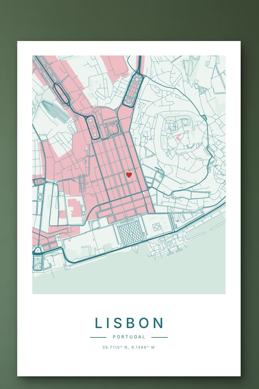 A pale green and pink city map poster of central Lisbon with a small heart in the Baixa, hanging on a sage green wall.